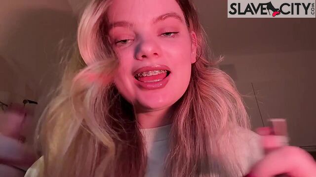 Beautiful Blonde Whispers Something Into The Microphone And Puts On Lipstick
