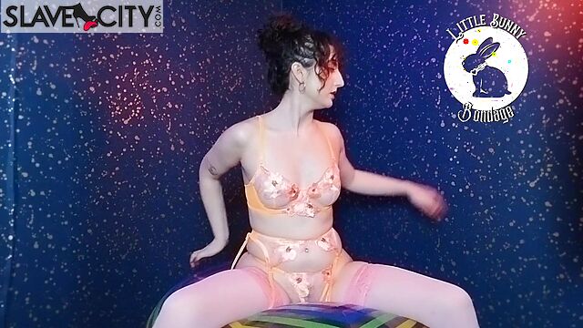 A Brunette In Beautiful Lingerie And Stockings Sits On A Ball And Imitates Fucking